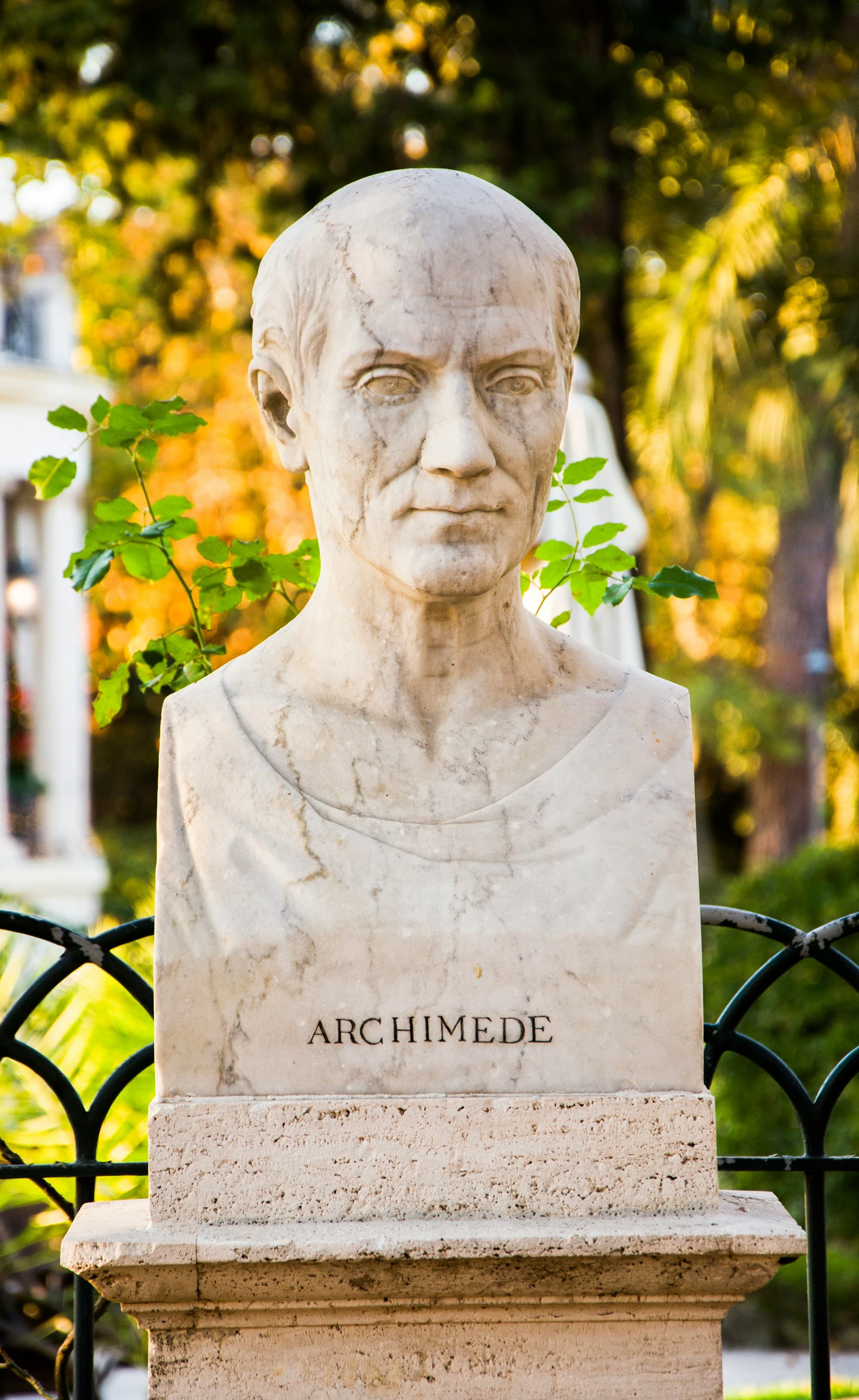 marble bust of archimedes with carved name on the pedestal, outdoors